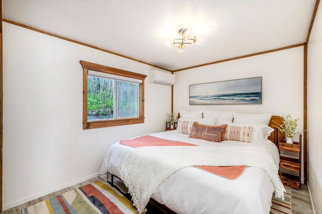 123 Jasper Street, Unit 35 Encinitas, CA 92024 - Photo 18 of 28 a bedroom with a bed and a chandelier