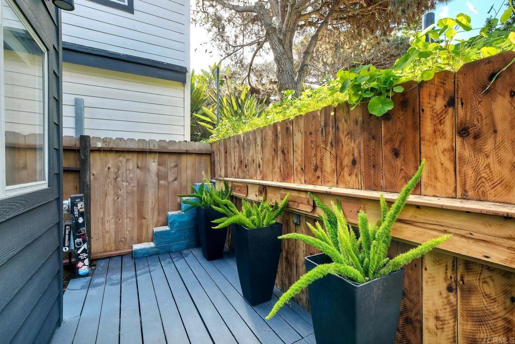 123 Jasper Street, Unit 35 Encinitas, CA 92024 - Photo 23 of 28 a plant on a wooden fence