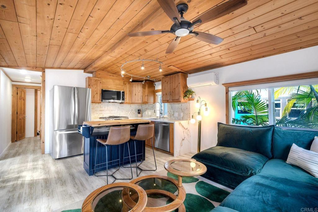 123 Jasper Street, Unit 35 Encinitas, CA 92024 - Photo 6 of 28 a kitchen with a table chairs refrigerator and couch