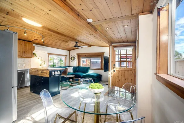 a dining room with furniture a window and wooden floor