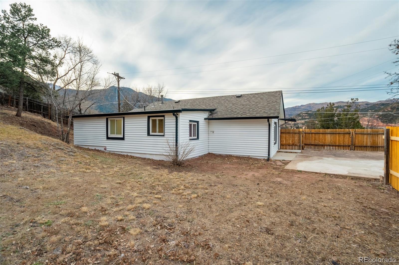 202 Oklahoma Road Manitou Springs, CO 80829 - Photo 35 of 41 a backyard of a house with a yard and garage