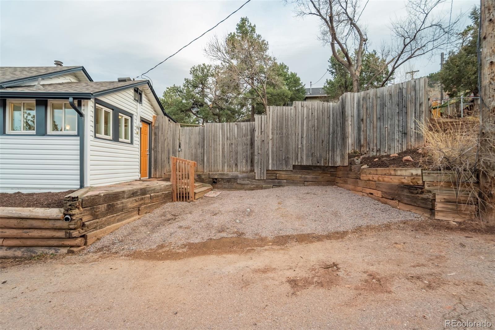 202 Oklahoma Road Manitou Springs, CO 80829 - Photo 4 of 41 a backyard of a house with table and chairs