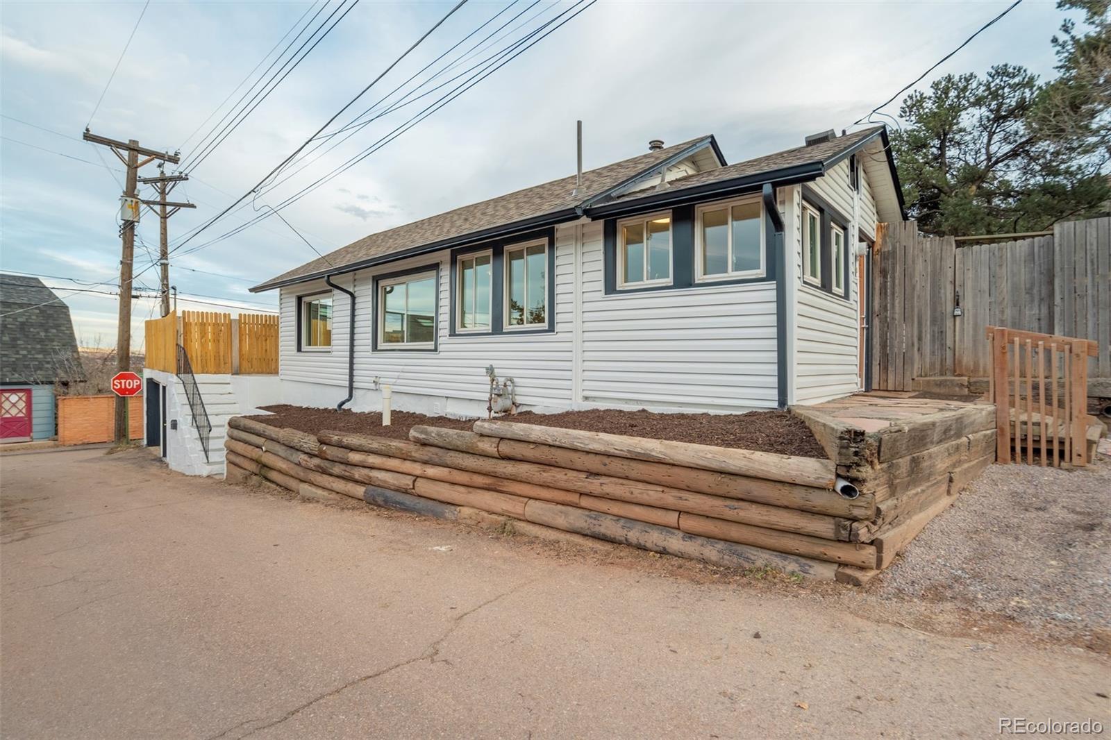 202 Oklahoma Road Manitou Springs, CO 80829 - Photo 5 of 41 a view of a house with a backyard and deck