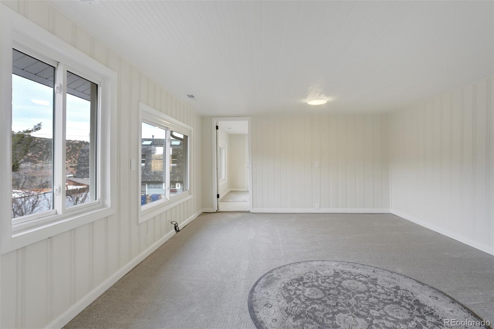 202 Oklahoma Road Manitou Springs, CO 80829 - Photo 10 of 41 an empty room with windows