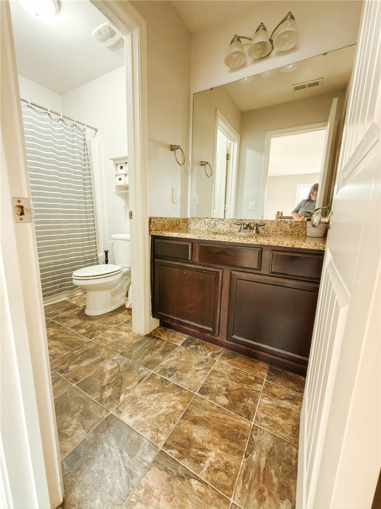 2409 Watkins Road Anderson, SC 29625 - Photo 32 of 44 This bathroom features a single vanity and a shower with a shower curtain.