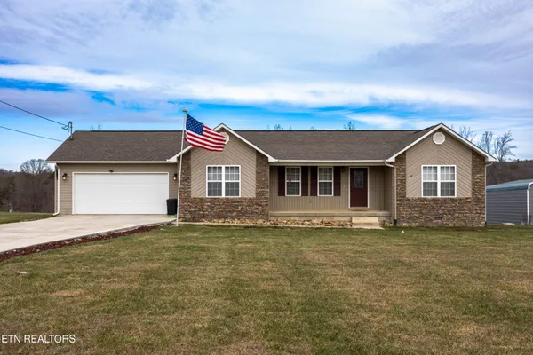 a view of front of house with a yard