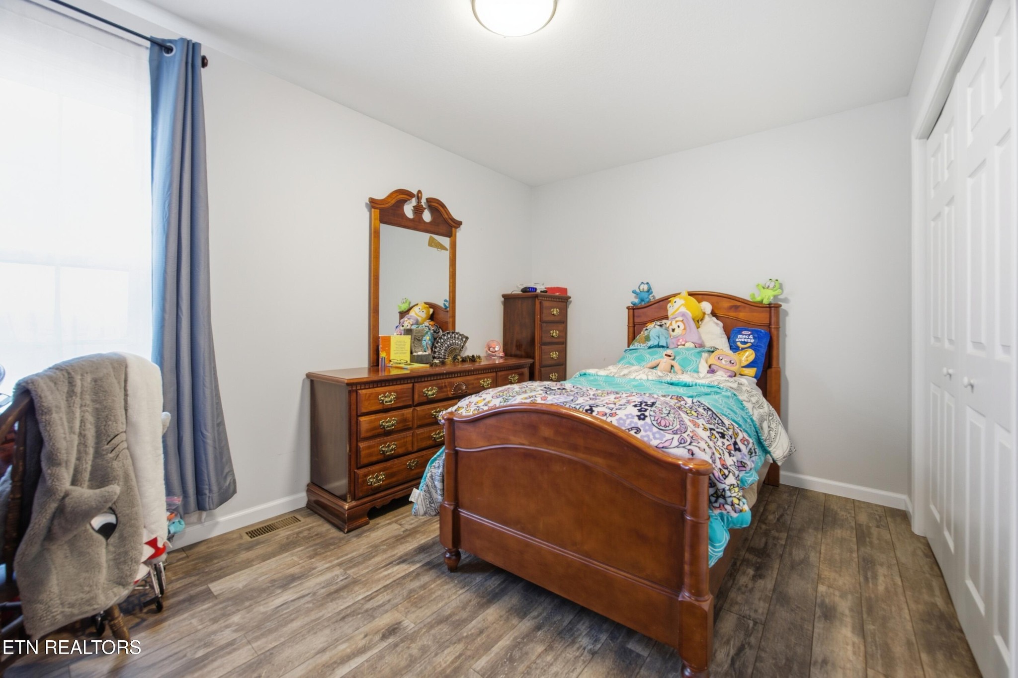 722 Williams Creek Road Oneida, TN 37841 - Photo 15 of 22 a bedroom with a bed a dresser and a window