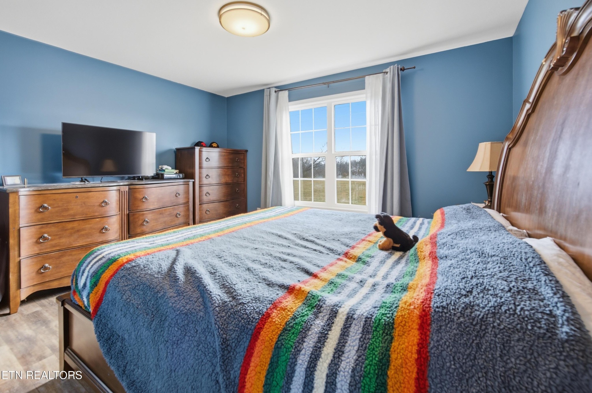 722 Williams Creek Road Oneida, TN 37841 - Photo 9 of 22 a bedroom with a bed and a flat screen tv
