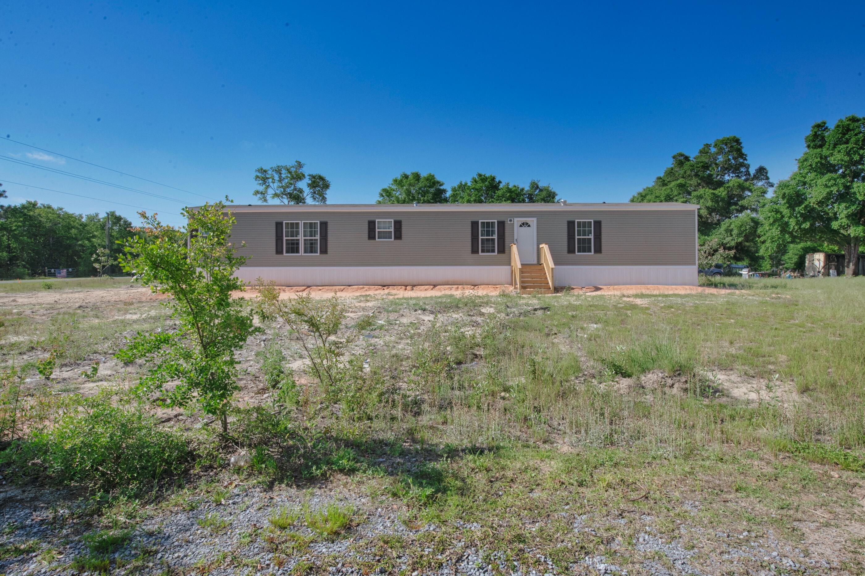 2791 Oakridge Road DeFuniak Springs, FL 32433 - Photo 1 of 10 a view of a house with a yard