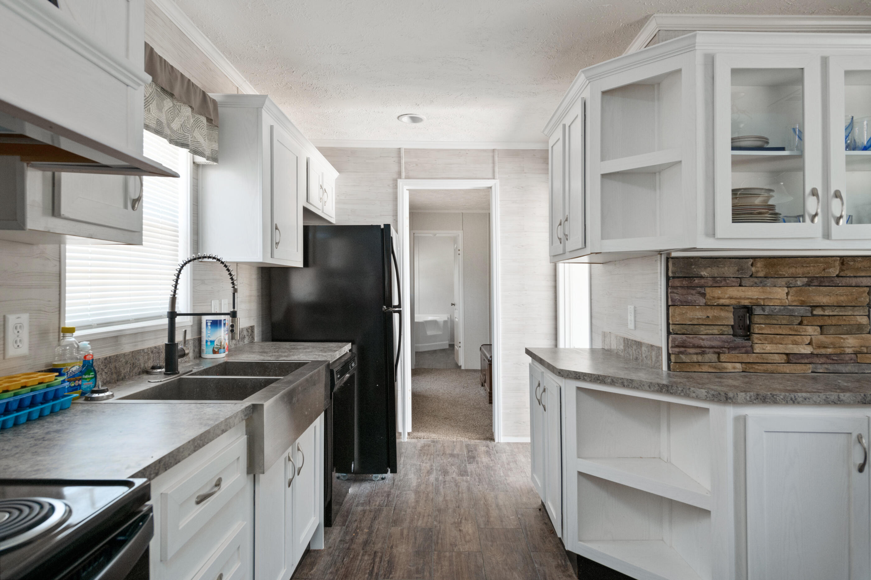 2791 Oakridge Road DeFuniak Springs, FL 32433 - Photo 2 of 10 a kitchen with granite countertop a refrigerator and a sink