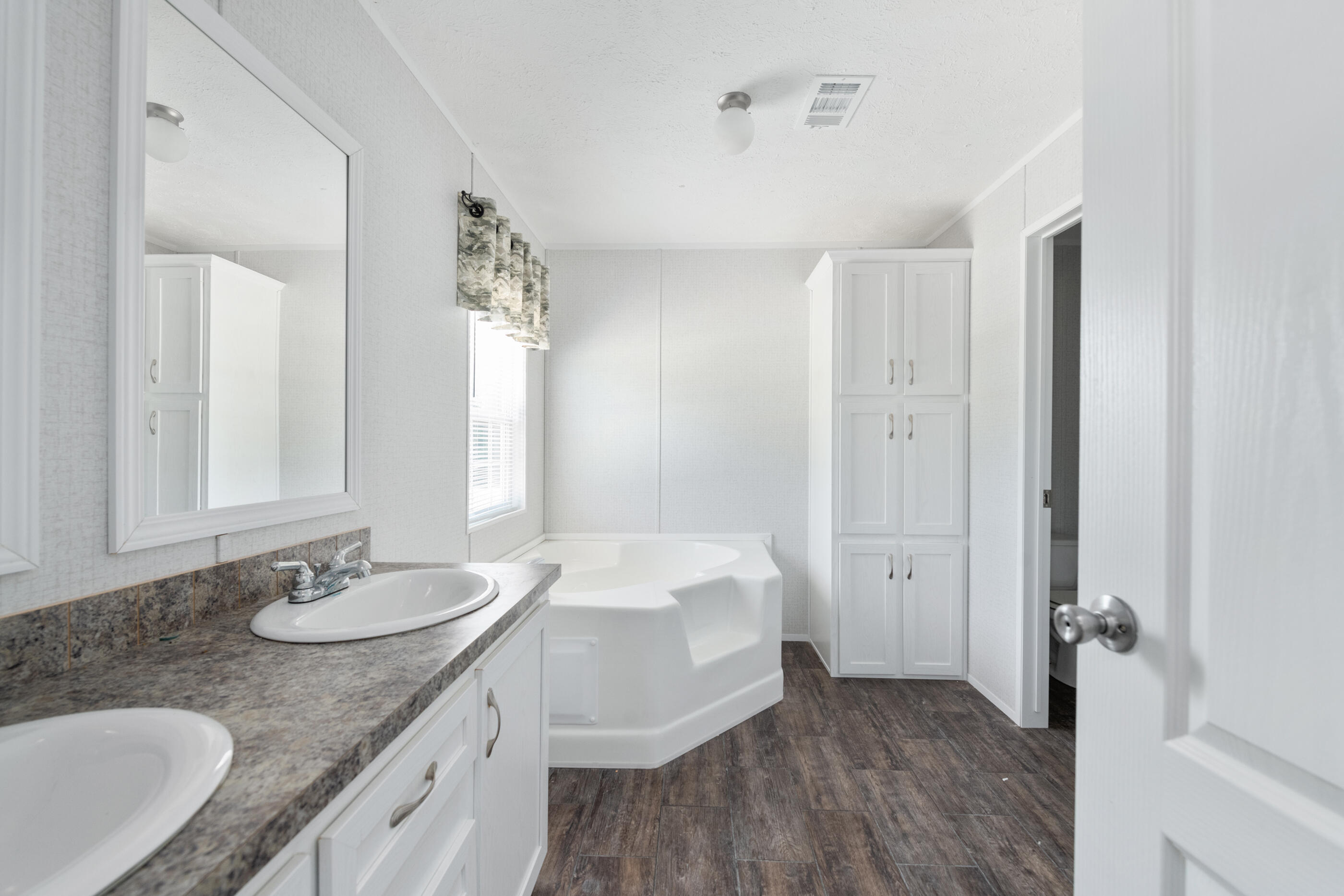 2791 Oakridge Road DeFuniak Springs, FL 32433 - Photo 4 of 10 a bathroom with a granite countertop sink and a mirror