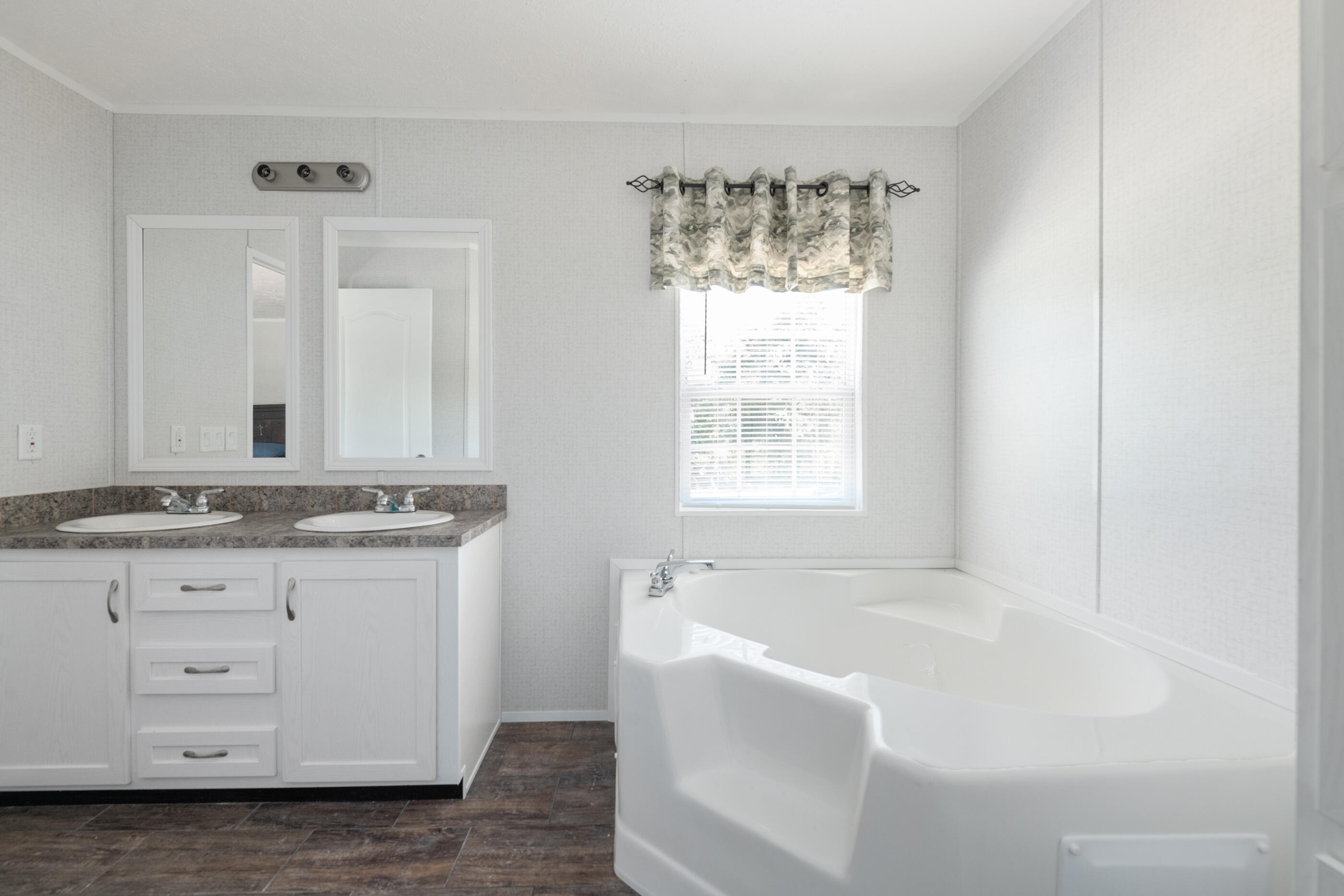 2791 Oakridge Road DeFuniak Springs, FL 32433 - Photo 5 of 10 a bathroom with a granite countertop sink and mirror with bathtub