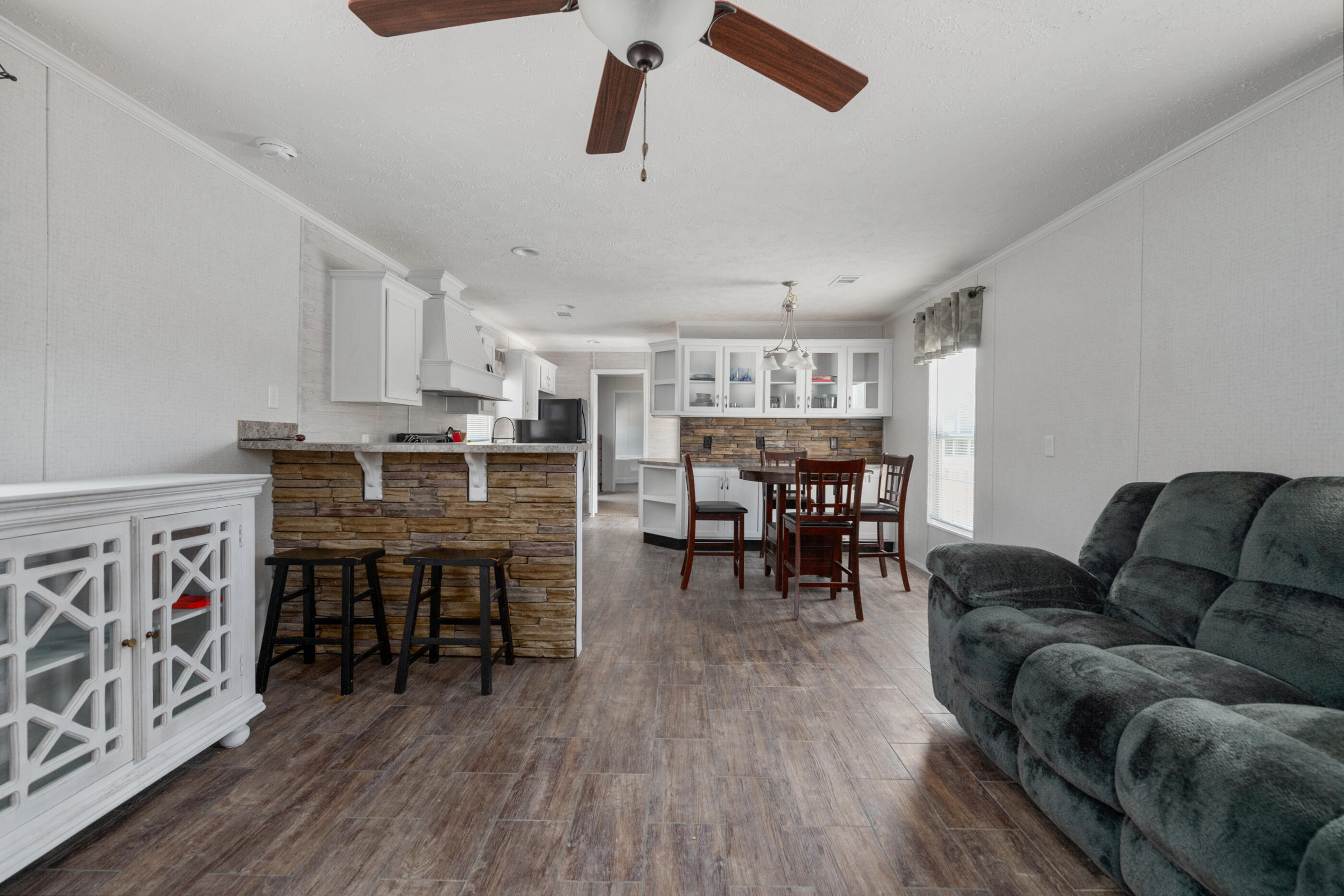 2791 Oakridge Road DeFuniak Springs, FL 32433 - Photo 9 of 10 a living room with furniture and kitchen view with wooden floor