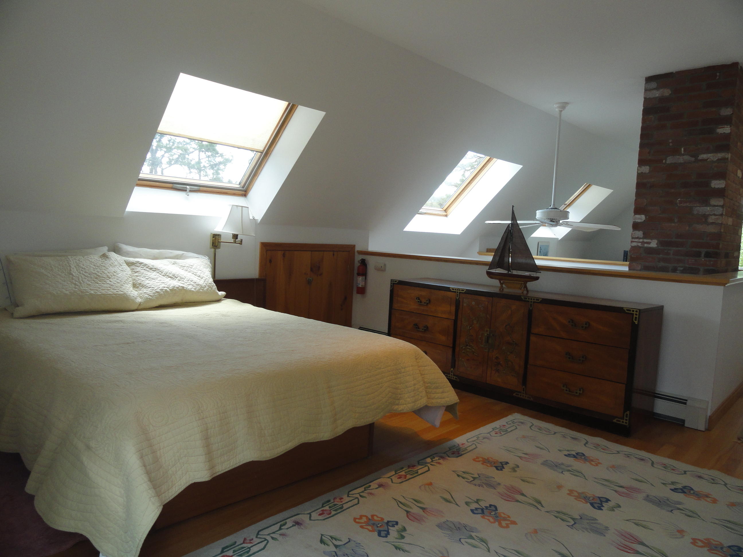 69 Bay View Road Wellfleet, MA 02667 - Photo 11 of 34 a bedroom with a bed and a dresser