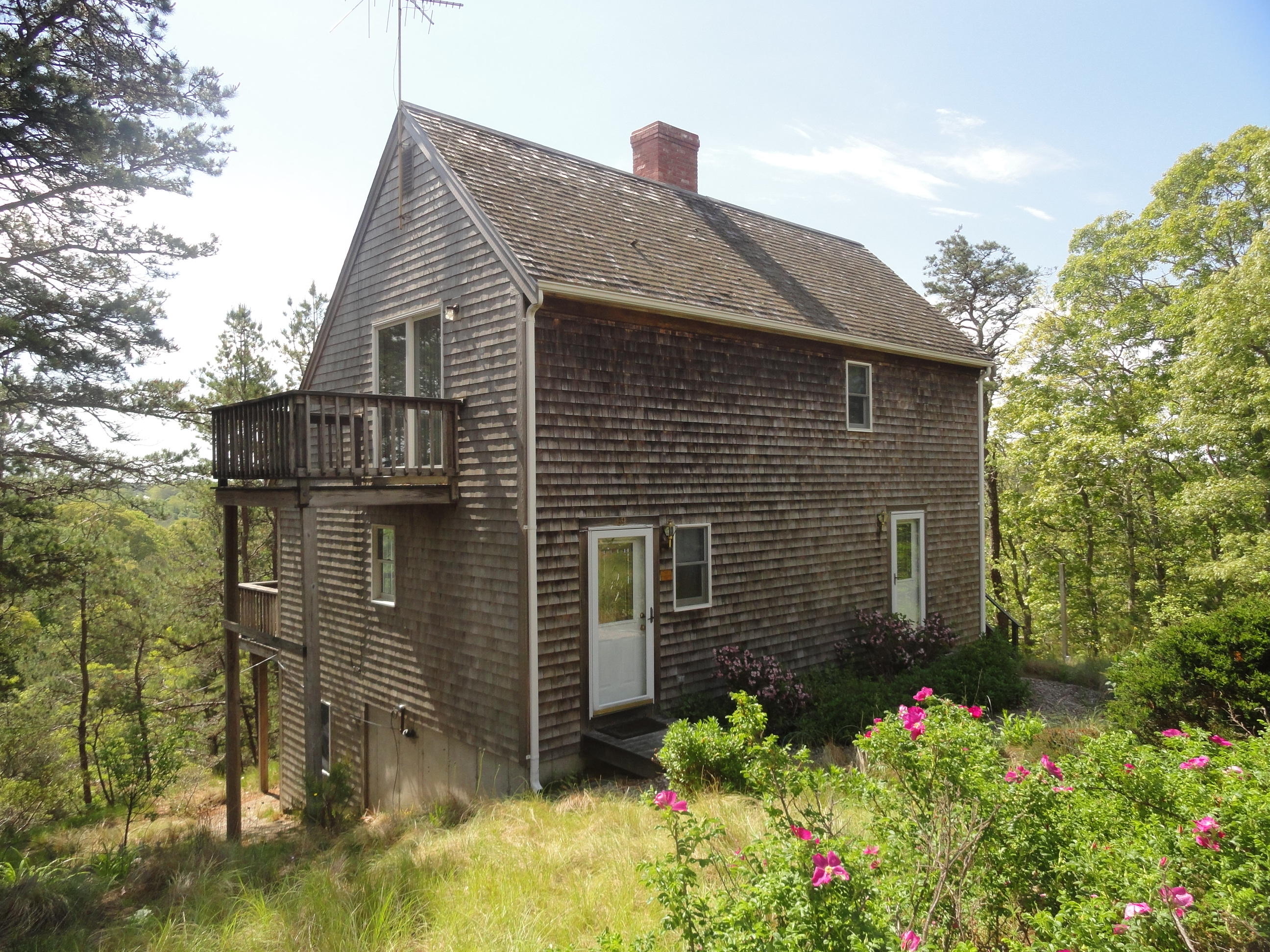 69 Bay View Road Wellfleet, MA 02667 - Photo 2 of 34 a front view of a house with plants