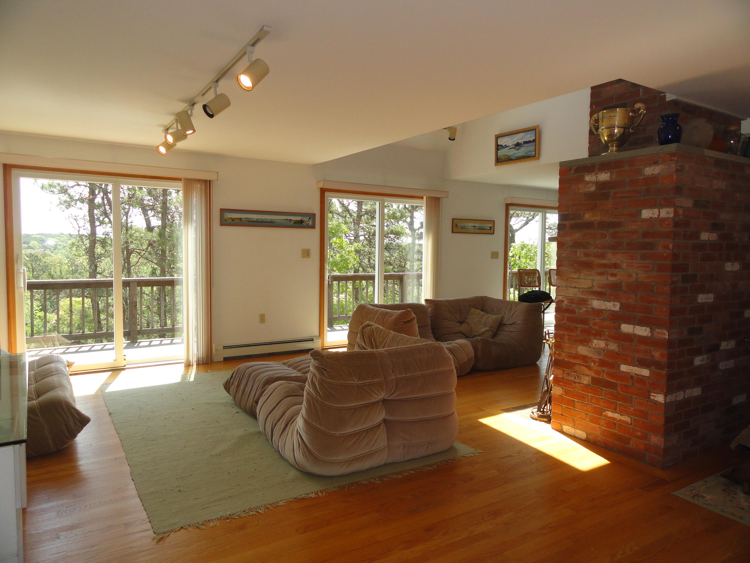 69 Bay View Road Wellfleet, MA 02667 - Photo 3 of 34 a living room with furniture large windows and wooden floor