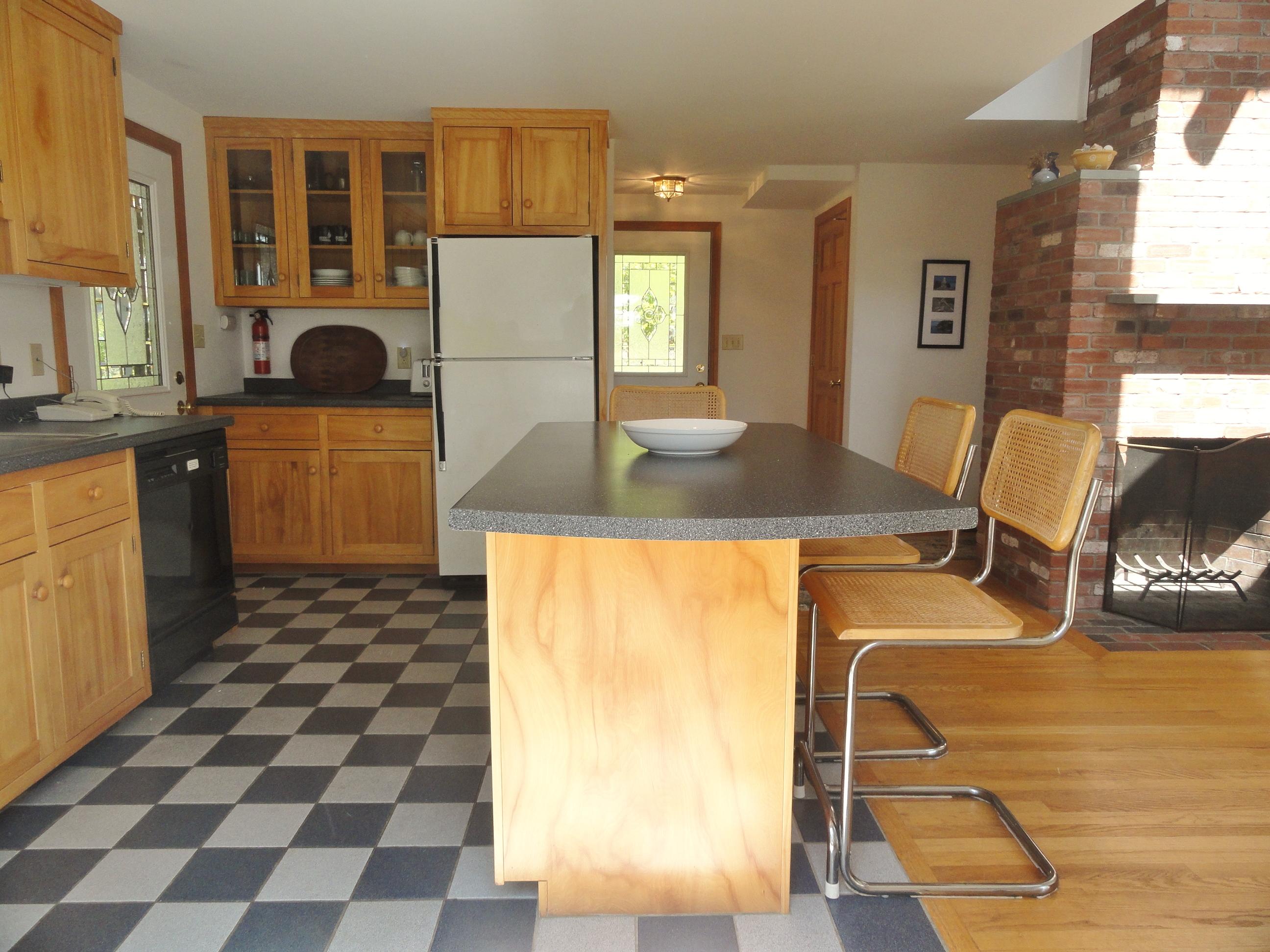 69 Bay View Road Wellfleet, MA 02667 - Photo 8 of 34 a kitchen with a sink a stove and a refrigerator