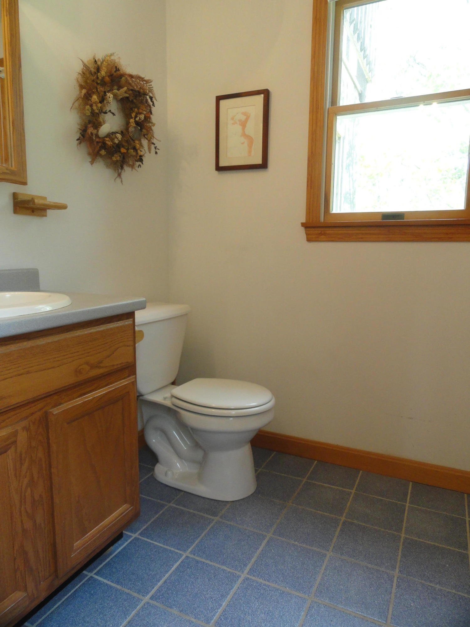 69 Bay View Road Wellfleet, MA 02667 - Photo 9 of 34 a white toilet sitting next to a bathroom sink