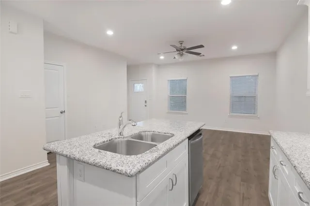 a kitchen with a sink dishwasher and a refrigerator