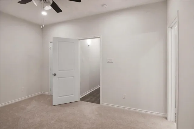 an empty room with view of ceiling fan