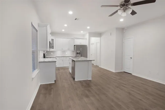 a view of kitchen with wooden floor and window