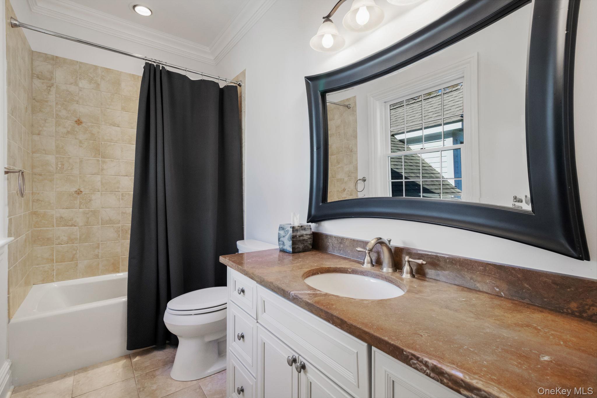 496 Long Ridge Road Bedford, NY 10576 - Photo 27 of 49 Bathroom featuring shower / bathtub combination with curtain, vanity, ornamental molding, and light tile patterned flooring
