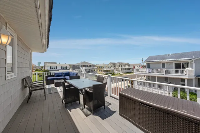 a view of a balcony with wooden benches