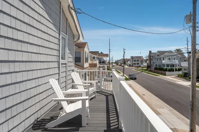 a view of a balcony with wooden floor and furniture