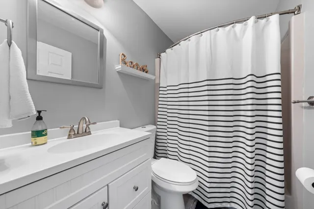 a view of a lake from a table and chairs in patio