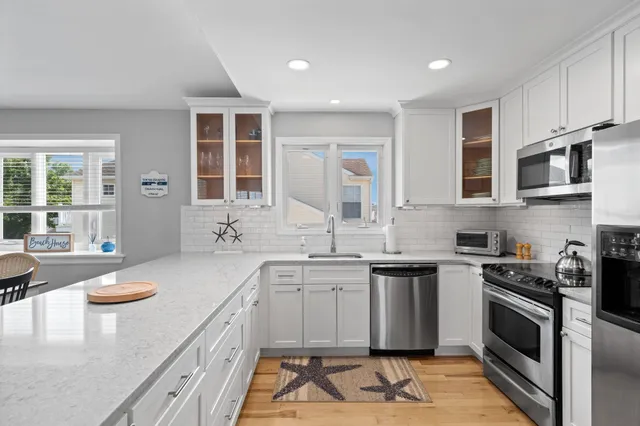 a kitchen with sink a stove and cabinets