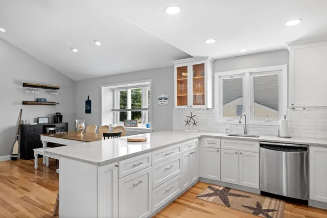 a kitchen with a sink stove and cabinets