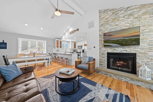a living room with furniture a fireplace and a table