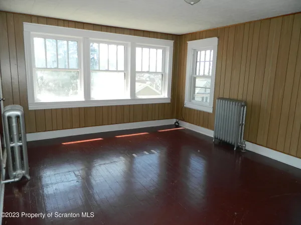 a view of room with window and wooden floor