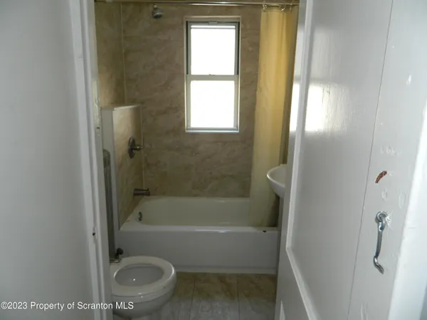 a bathroom with a sink a toilet and a bathtub