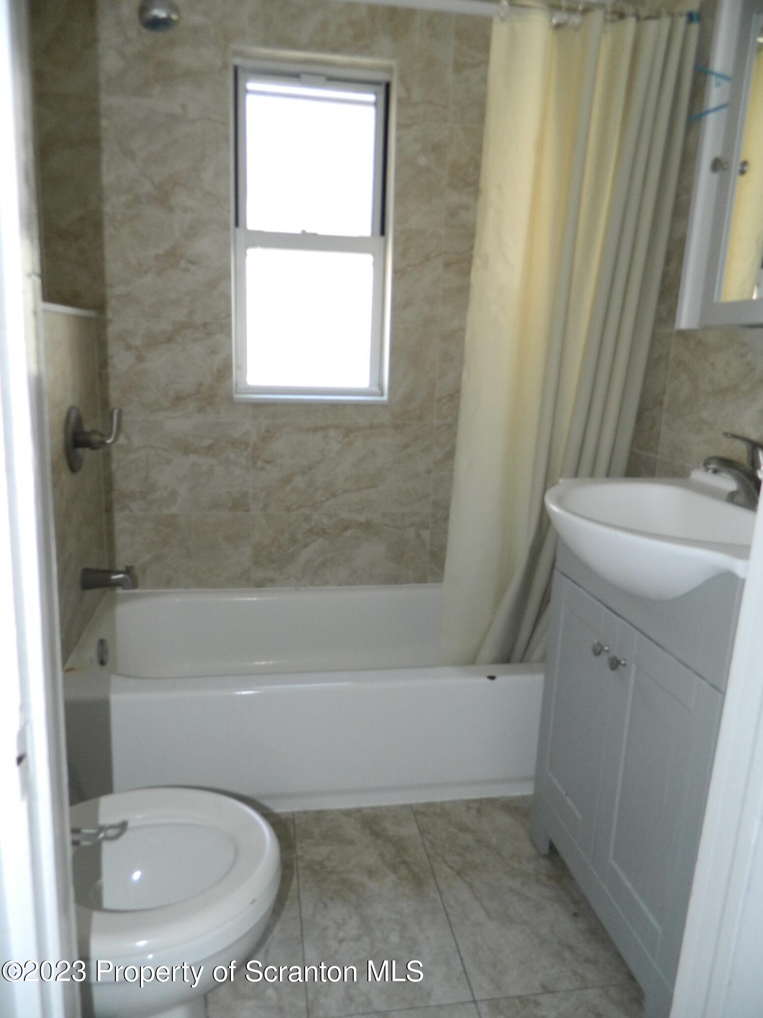 127 East Pine Street Dunmore, PA 18512 - Photo 20 of 20 a bathroom with a sink a toilet and a bathtub