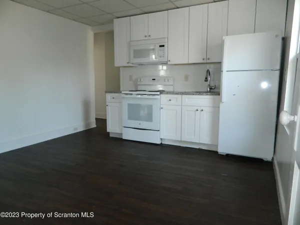 a kitchen with a sink a stove and refrigerator