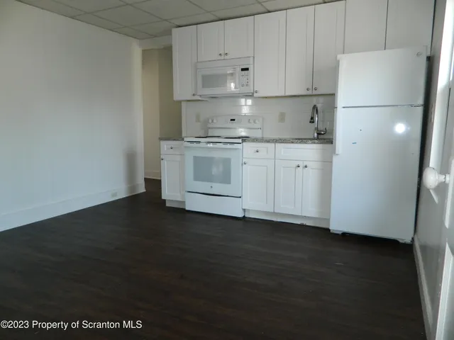 a kitchen with a sink a stove and refrigerator