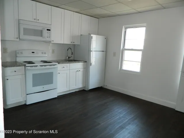 a kitchen with stainless steel appliances a refrigerator sink and cabinets