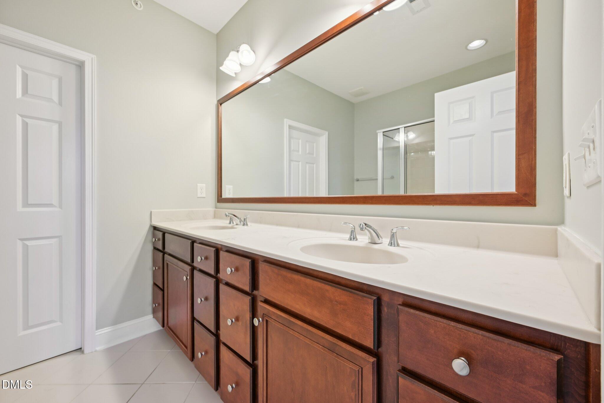 10510 Sablewood Drive, Unit 113 Raleigh, NC 27617 - Photo 25 of 38 a bathroom with a sink and a mirror