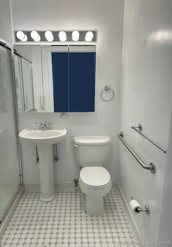 a bathroom with a sink toilet and a mirror