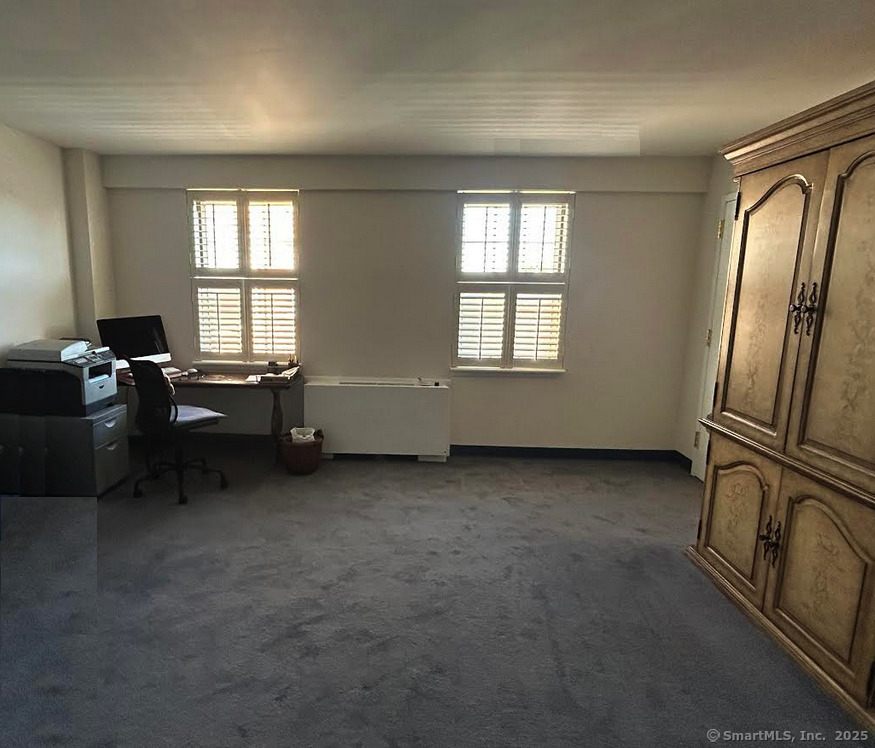 59 Courtland Avenue, Unit 3K Stamford, CT 06902 - Photo 12 of 31 a view of a livingroom with furniture staircase and windows