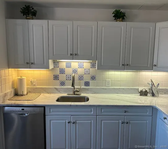 a kitchen with a sink cabinets and window