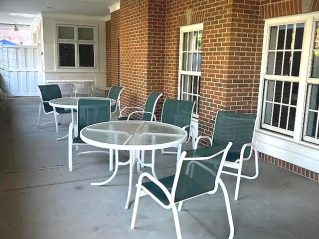 a balcony with table and chairs