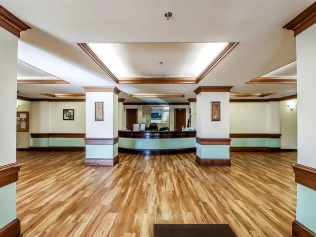 a living room with lots of furniture and wooden floor