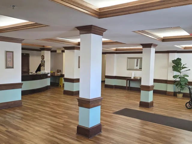 a view of living room with furniture and wooden floor