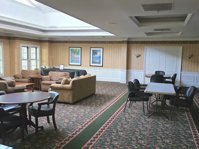 a living room with furniture wooden floor and a window