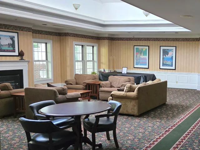 a living room with furniture wooden floor and a fireplace