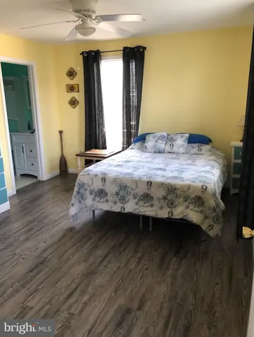 a bedroom with a bed and a mirror