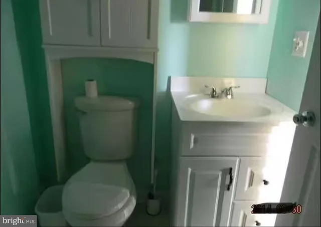 a bathroom with a toilet sink and mirror
