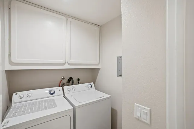 a outdoor living space with a couch and potted plants